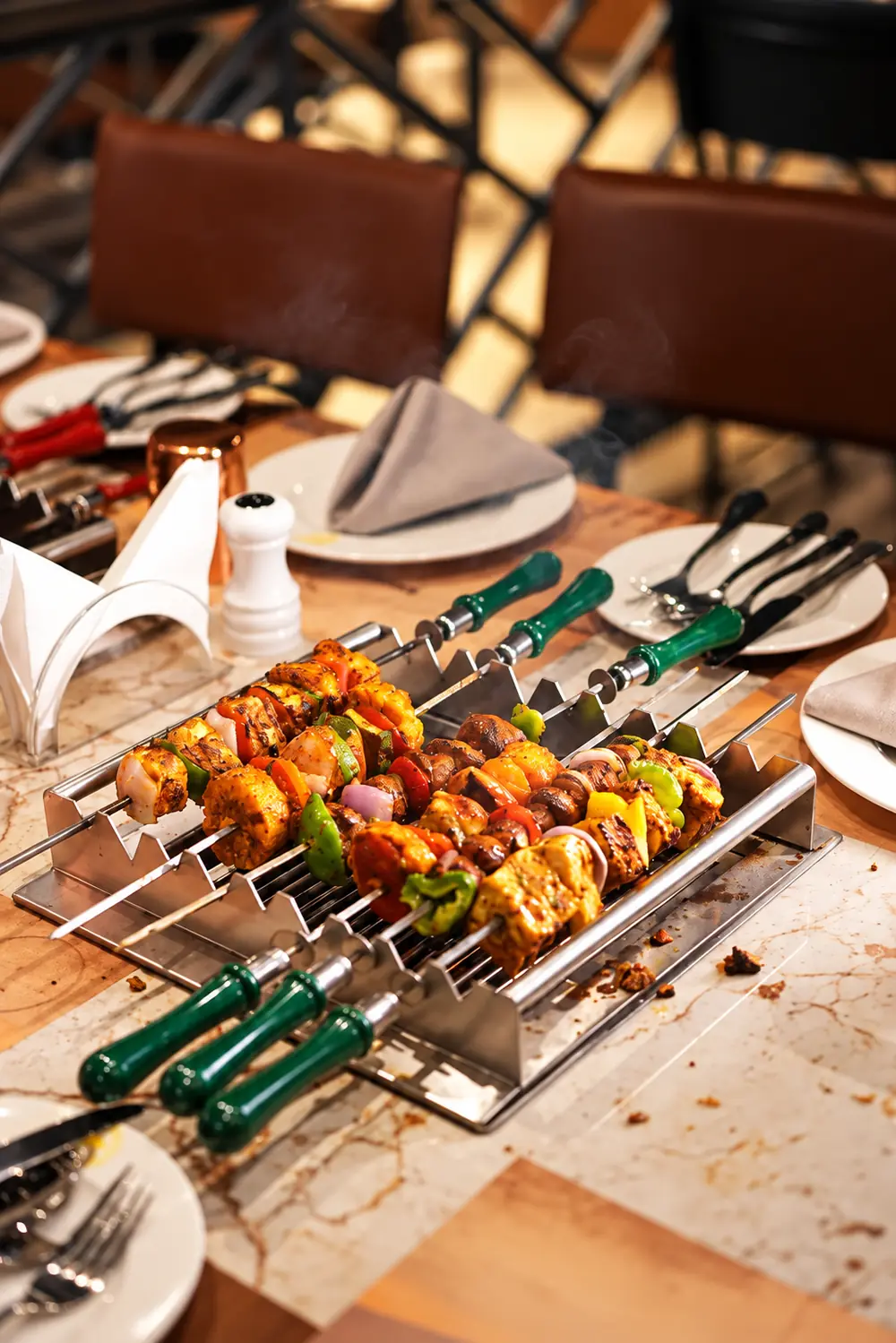 Skewers resting on a table grill